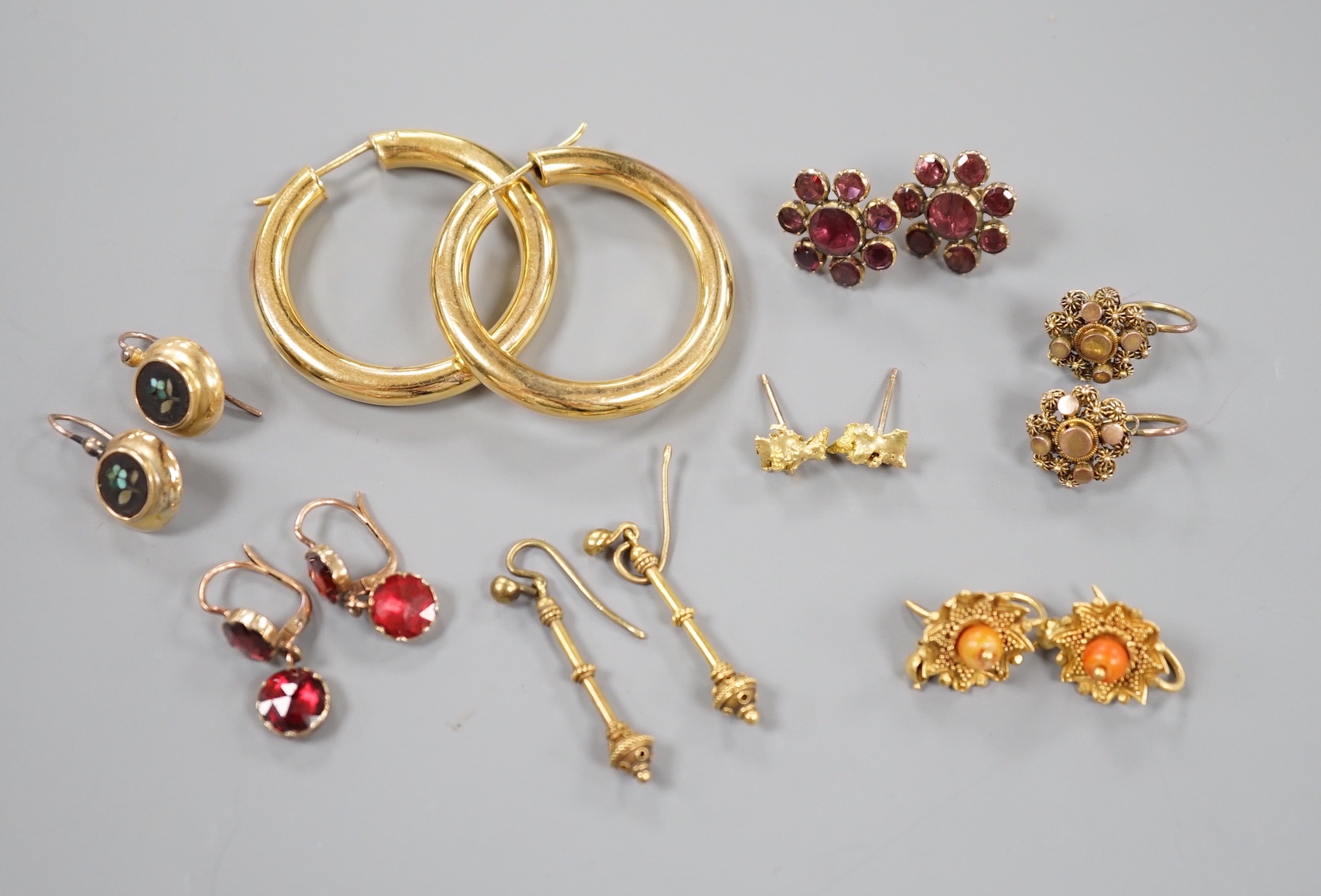 Eight assorted pairs of yellow metal or yellow metal and gem set earrings, including two pairs of Victorian garnet set, coral bead set, nugget and 9ct gold hoop